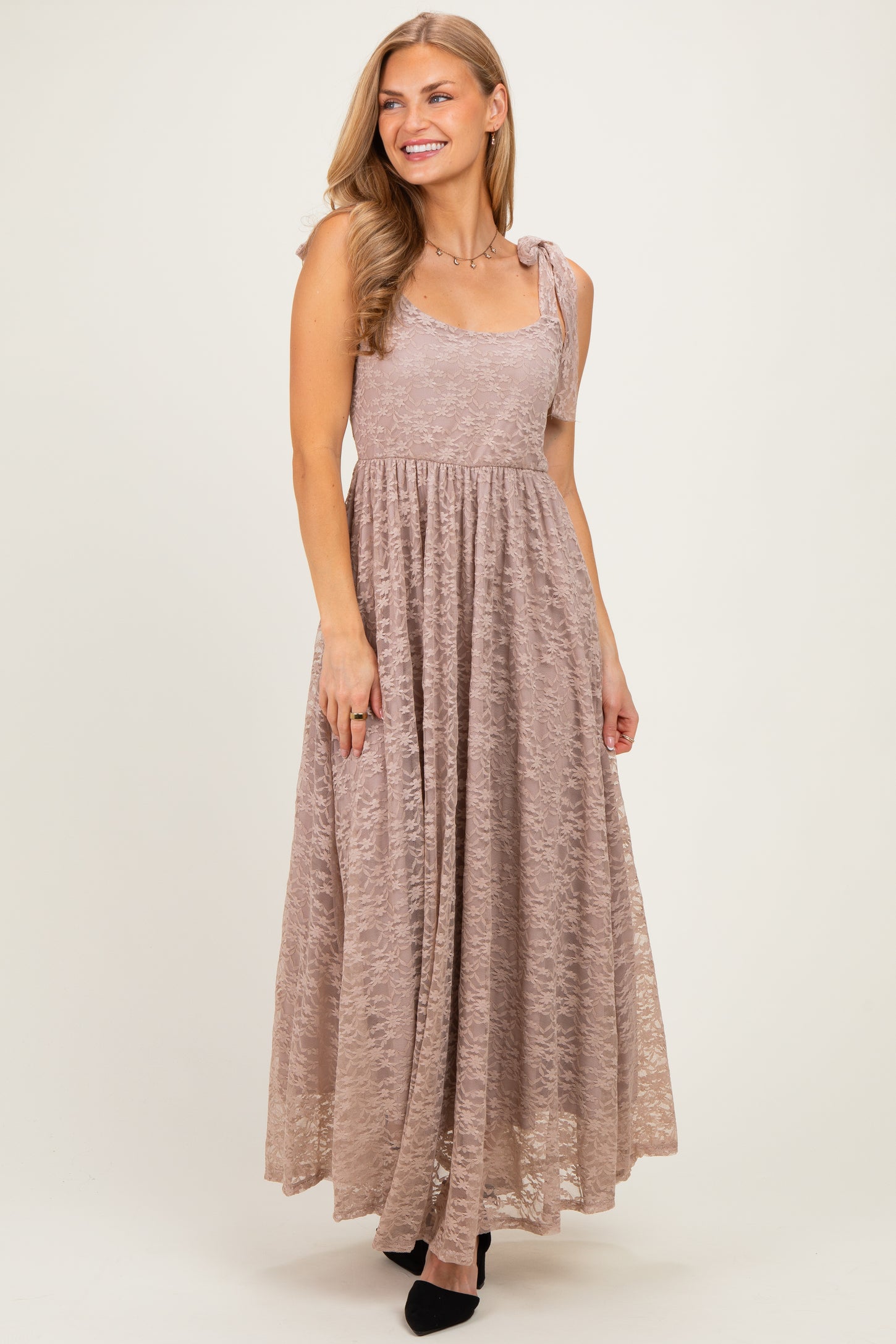 woman wearing a dusty mauve maxi dress with lace details and adjustable shoulder straps
