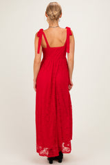 woman wearing a red lace maxi dress with tied shoulder straps, shown from the back