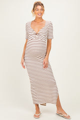 woman wearing a striped maternity maxi dress with a twist front and short sleeves, showing her baby bump