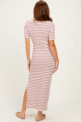 woman wearing a striped maxi dress with short sleeves and a side slit, standing with her back to the camera