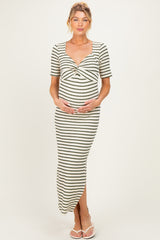 woman wearing a striped maternity maxi dress with short sleeves and a scoop neckline, holding her baby bump