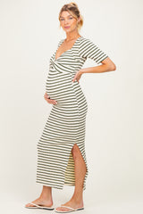 woman wearing a striped maternity dress with a twist front and side slit, showing her baby bump