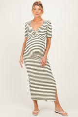 woman wearing a striped maternity maxi dress with a twisted front and a side slit, highlighting her baby bump
