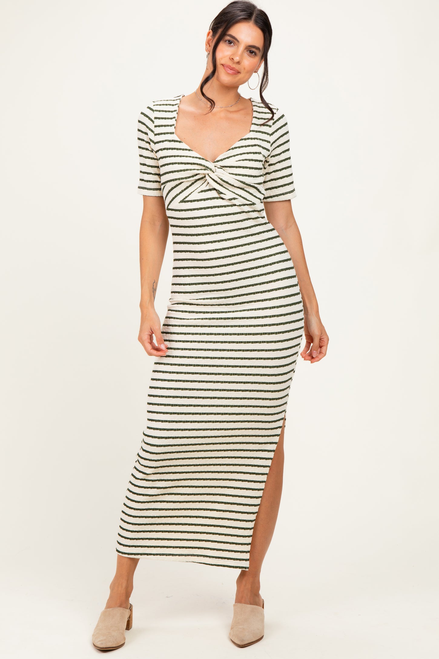 woman wearing a striped midi dress with a cinched front detail and short sleeves