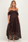 woman wearing a chocolate brown off-the-shoulder maternity dress with lace detailing and a flowing high-low hem, showing baby bump
