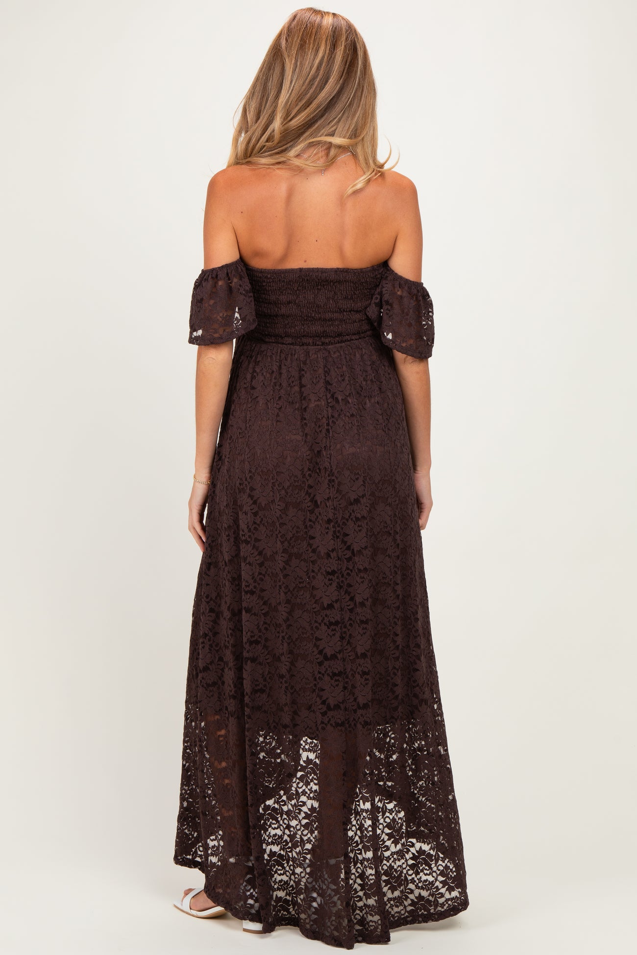 woman wearing a brown off-the-shoulder lace maternity maxi dress with a smocked bodice and flowy skirt