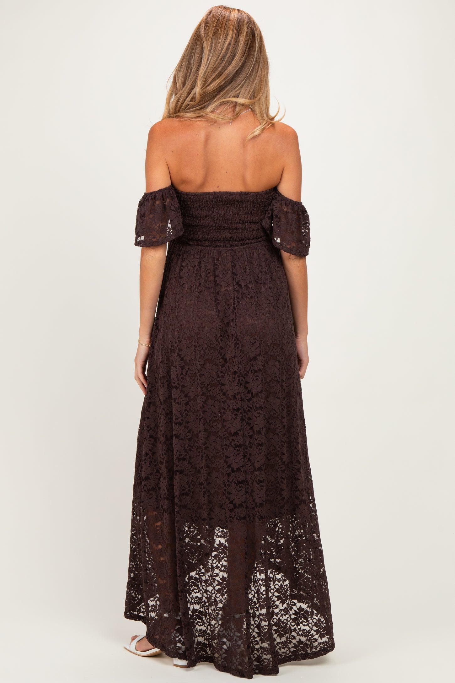woman wearing a brown off-the-shoulder lace maternity maxi dress with a smocked bodice and flowy skirt