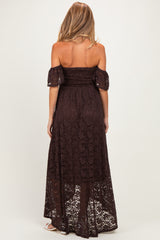 woman wearing a brown off-the-shoulder lace maternity maxi dress with a smocked bodice and flowy skirt