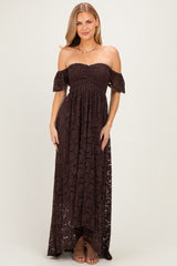 woman wearing a brown off-the-shoulder lace maxi dress with a fitted bodice and flowing skirt