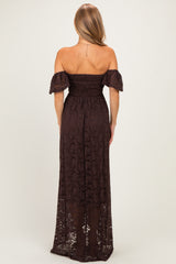 woman wearing a dark brown off-the-shoulder maxi dress with lace details and short puff sleeves, shown from the back