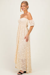 woman wearing a cream off-the-shoulder lace maxi dress with puff sleeves and a smocked bodice