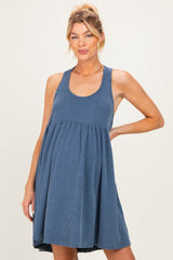 woman wearing a striped blue maternity dress with a relaxed fit and sleeveless design, showing a baby bump