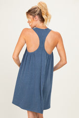 woman wearing a blue striped maternity dress with a racerback style and flared skirt