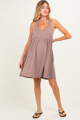 woman wearing a brown striped maternity dress with a relaxed fit and flared skirt, highlighting her baby bump