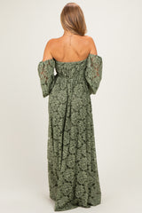 woman wearing a green off-the-shoulder maxi dress with long puff sleeves and intricate lace details