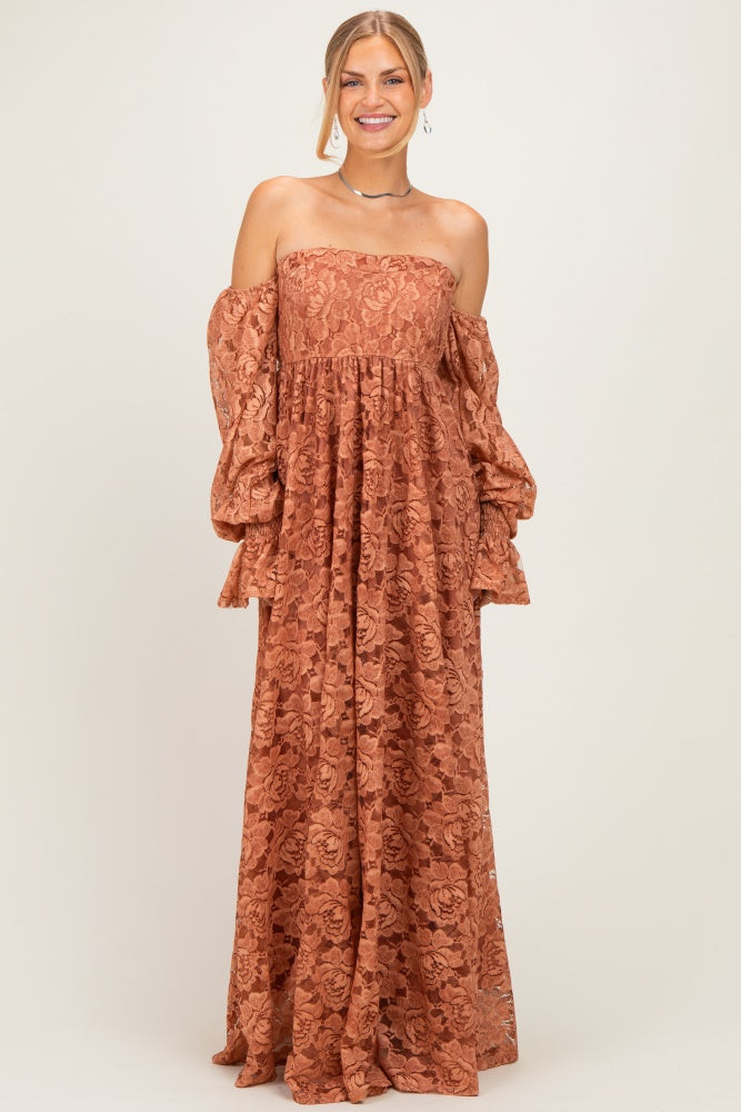 woman wearing a rust off-the-shoulder maxi dress with bell sleeves and floral lace details