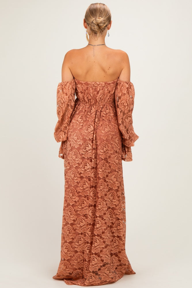 woman wearing a rust-colored lace off-the-shoulder dress with long puff sleeves and a fitted silhouette from the back