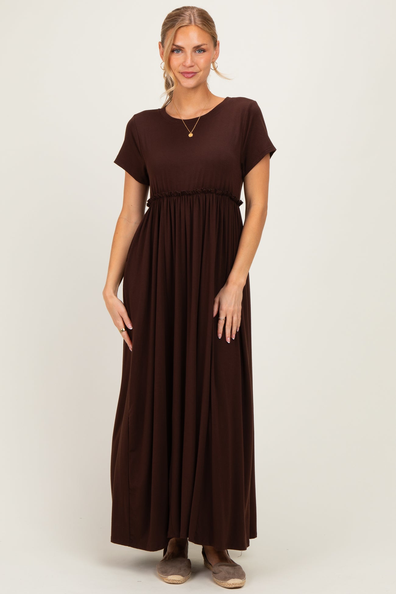 woman wearing a brown short sleeve maxi dress with a gathered waist and relaxed fit