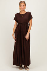 woman wearing a brown short sleeve maxi dress with a gathered waist and relaxed fit