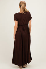 woman wearing a dark brown short sleeve maxi dress with an elastic waist from the back