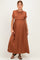 woman wearing a rust brown short sleeve maternity maxi dress, showing her baby bump
