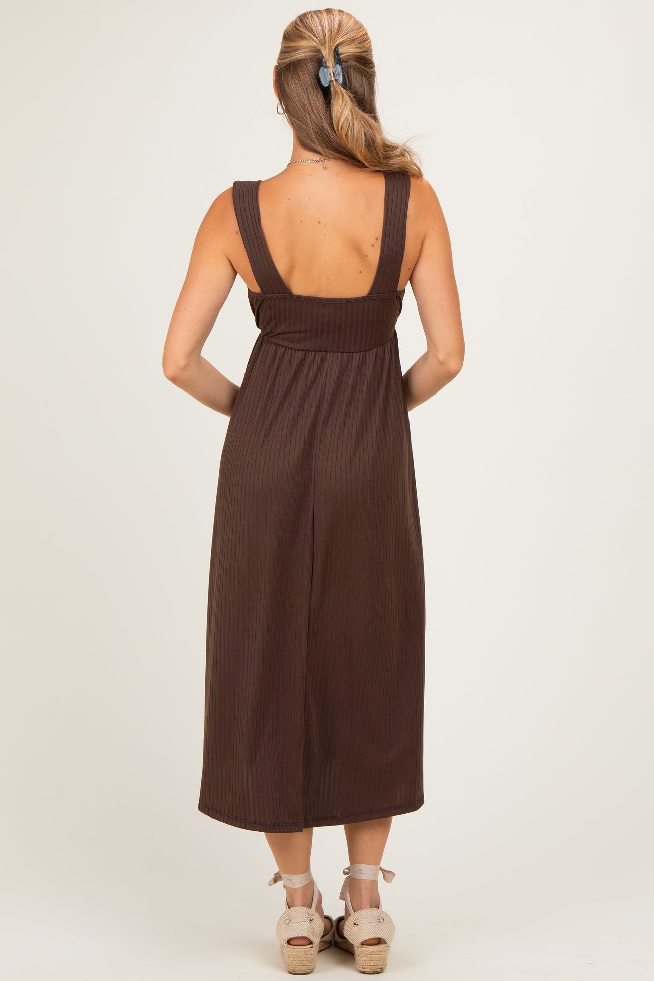 woman wearing a brown ribbed maxi dress with wide straps, shown from the back