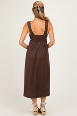 woman wearing a brown ribbed maxi dress with wide straps, shown from the back