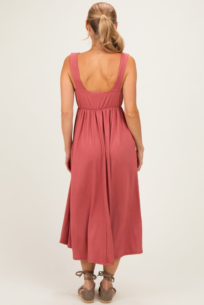 woman wearing a dusty rose sleeveless midi dress with a fitted waist and flowy skirt, viewed from the back