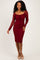 woman wearing a burgundy fitted lace dress with long sleeves and a square neckline