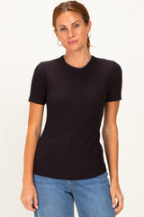 woman wearing a black ribbed short sleeve top with a round neck and casual blue jeans
