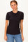 woman wearing a black ribbed short sleeve top with a round neck and casual blue jeans
