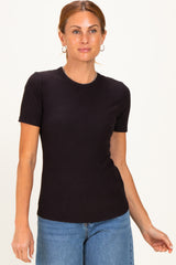 woman wearing a black short sleeve ribbed top and blue jeans