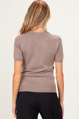woman wearing a short sleeve taupe maternity sweater viewed from the back