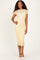 woman wearing a yellow lace midi dress with short sleeves, standing and smiling against a neutral background