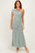 woman wearing a sage green one-shoulder maxi dress with ruching and a flowy bottom