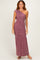 woman wearing a mauve one-shoulder maxi dress with ruching details and a flared hem