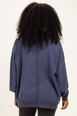 woman wearing a navy oversized sweatshirt with a relaxed fit and back seam detail
