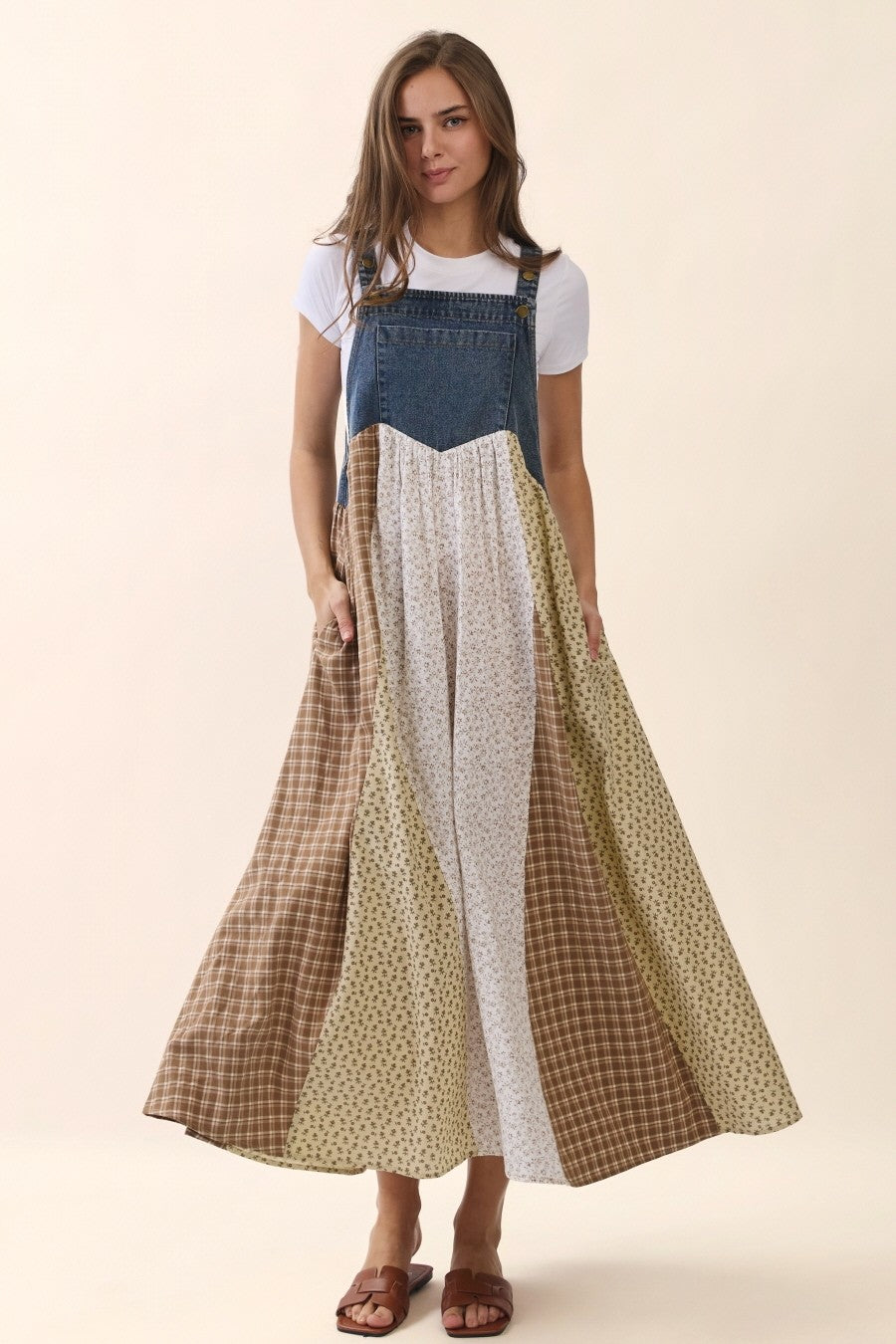 woman wearing a color-blocked maxi dress with a denim top and patterned skirt, standing with pockets