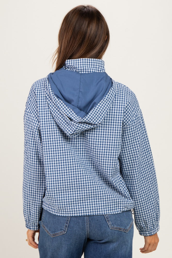 woman wearing a blue and white checkered maternity jacket, viewed from the back, with a blue hood