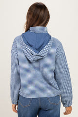 woman wearing a blue and white checkered maternity jacket, viewed from the back, with a blue hood