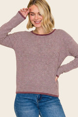 woman wearing a burgundy and cream striped long sleeve top with a relaxed fit and round neckline, smiling and posing