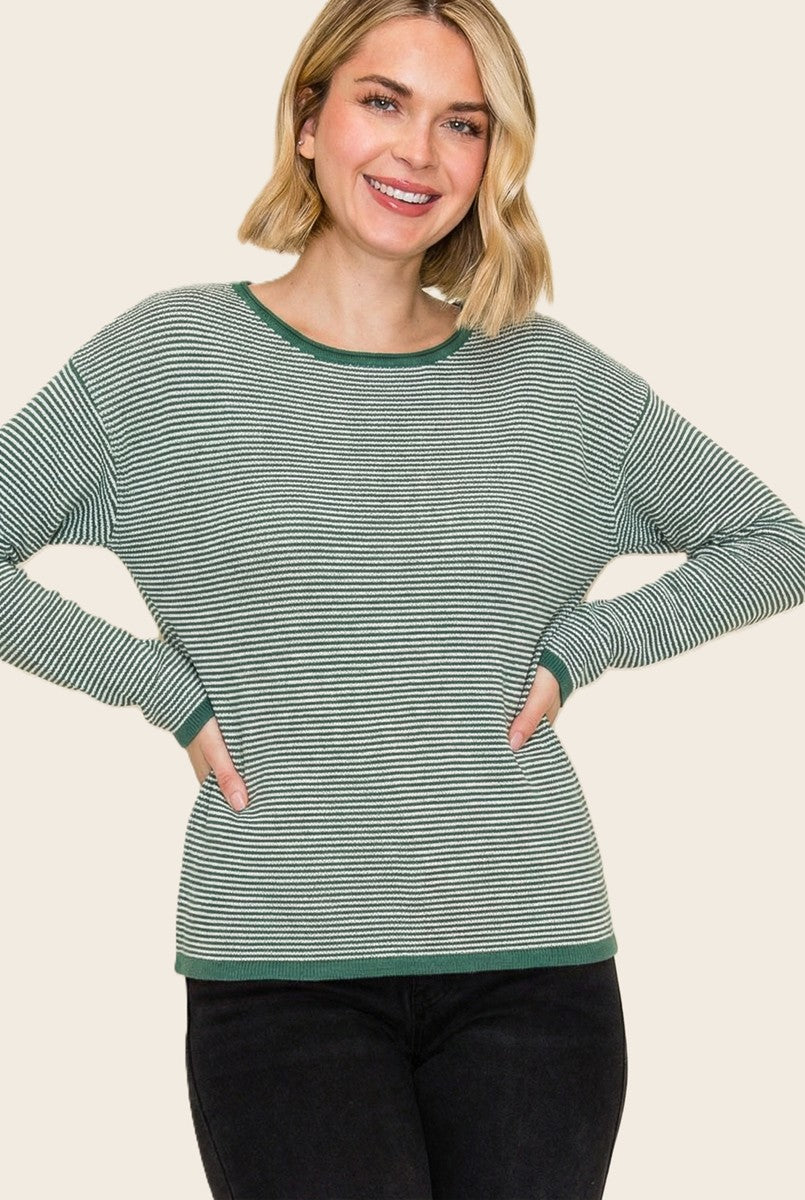 woman wearing a green and white striped long sleeve top with a relaxed fit and ribbed cuffs