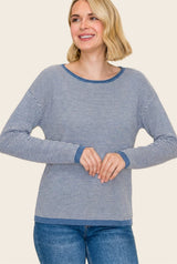 woman wearing a blue and white striped long sleeve sweater with a relaxed fit and contrasting neckline and cuffs