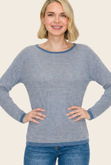 woman wearing a navy and white striped long sleeve top with a relaxed fit and blue trim, smiling at the camera