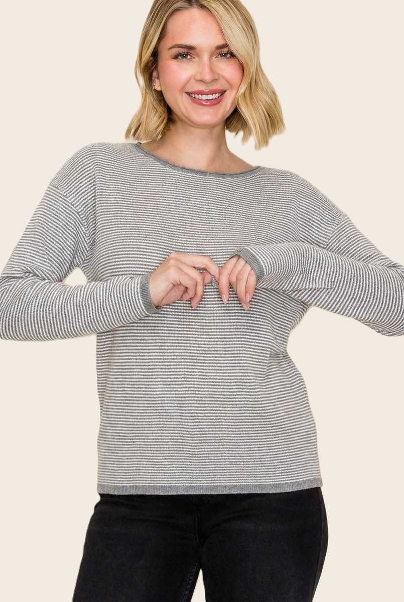 woman wearing a gray and white striped long sleeve sweater with wide neckline and relaxed fit