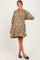 woman wearing a taupe paisley print maternity dress with a v-neck and balloon sleeves, showing her baby bump