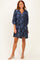 woman wearing a navy floral print short sleeve dress with a v-neck and loose fit