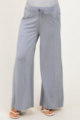 woman wearing light gray maternity wide-leg pants with a drawstring waist and pockets