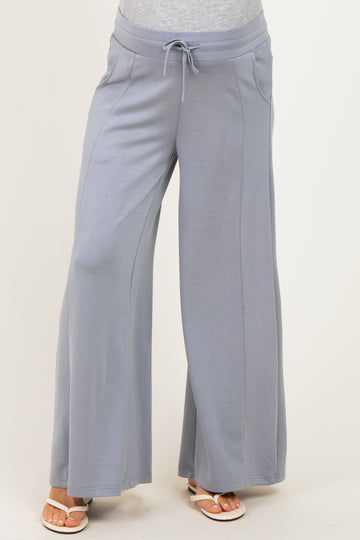 woman wearing light gray maternity wide-leg pants with a drawstring waist and pockets