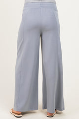 woman wearing a pair of light blue wide-leg maternity pants seen from the back